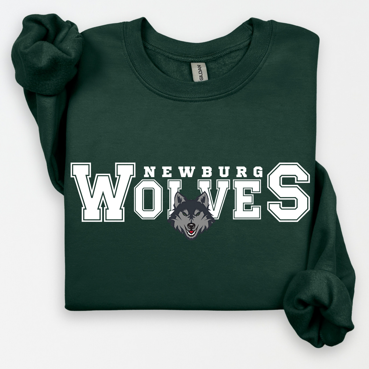 Newburg Wolves Varsity Pride design shown on a forest green crewneck
