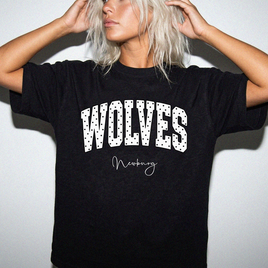 Newburg Wolves white polka-dot varsity graphic shown on black T-shirt