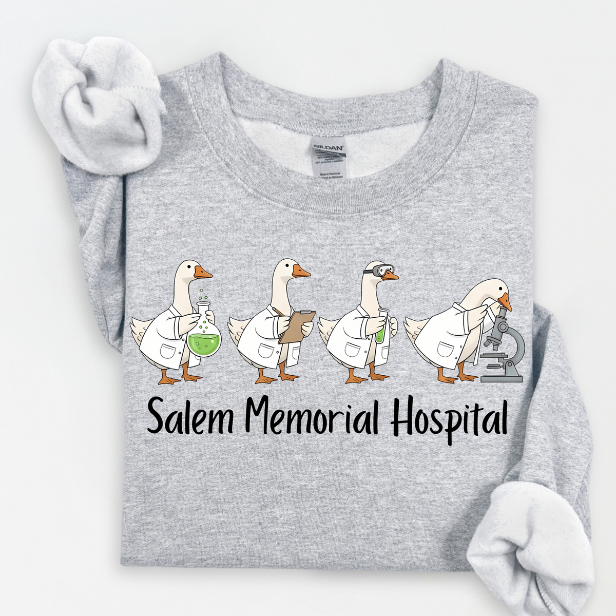 Four geese in lab coats with laboratory equipment and Salem Memorial Hospital lettering on a Sport Grey crewneck.